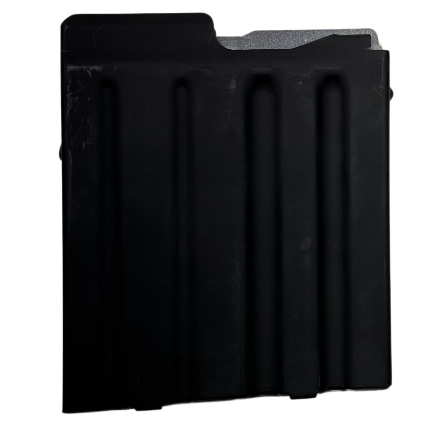 A black rectangular metal object with three vertical indentations resembles a component of the Cheytac M200 .408/.375 Magazine. The right edge features a protruding notch-like structure, and the upper right corner is slightly angled. The matte surface shows signs of mild wear, set against a solid white background. This product is manufactured by B&B Firearms.