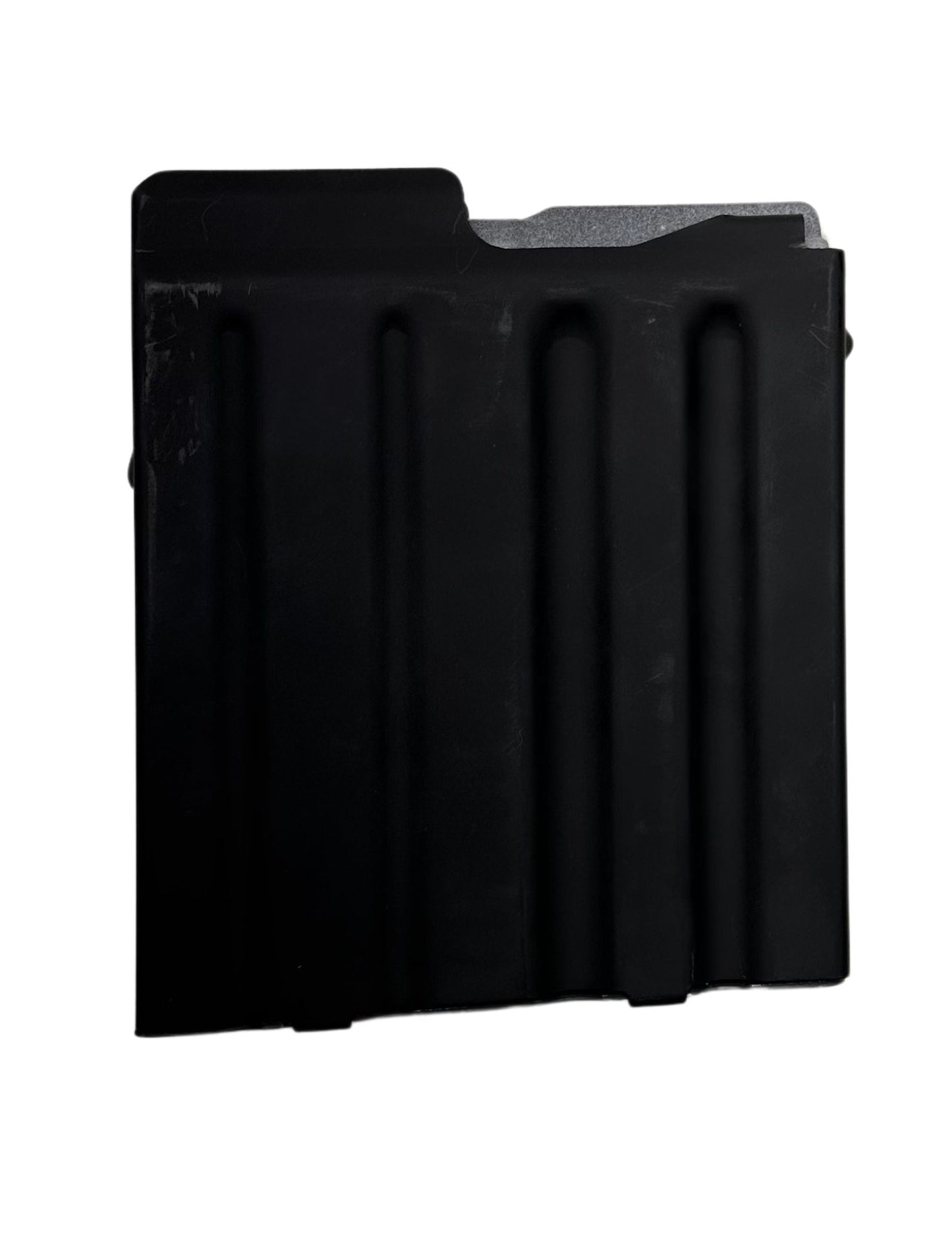 A black rectangular metal object with three vertical indentations resembles a component of the Cheytac M200 .408/.375 Magazine. The right edge features a protruding notch-like structure, and the upper right corner is slightly angled. The matte surface shows signs of mild wear, set against a solid white background. This product is manufactured by B&B Firearms.