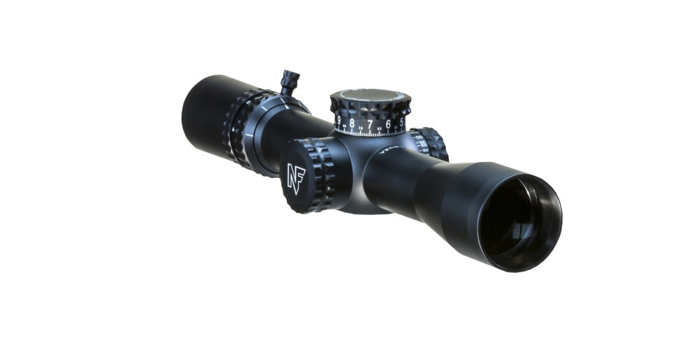 The Nightforce ATACR 4-16x42 F1 ZH .1mrad Illum PTL TReMor3 C575 from B&B Firearms is a black rifle scope featuring clear markings and ED glass for optimal clarity. The central adjustment knob, labeled "Nightforce ATACR," is prominently visible, along with additional precise adjustment knobs on the top and side. Its sleek design complements precision semi-automatic rifles perfectly.