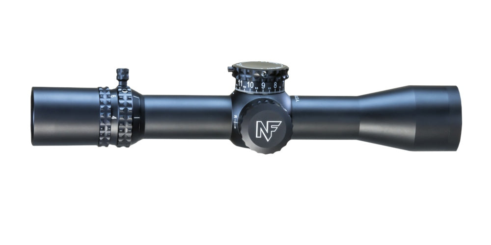 The Nightforce ATACR 4-16x42 F1 ZH .1mrad Illum PTL TReMor3 C575 from B&B Firearms is a black rifle scope featuring clear markings and ED glass for optimal clarity. The central adjustment knob, labeled "Nightforce ATACR," is prominently visible, along with additional precise adjustment knobs on the top and side. Its sleek design complements precision semi-automatic rifles perfectly.