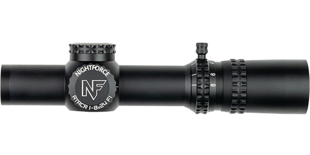 A black Nightforce ATACR 1-8x24 F1 .1 Mil-Radian NVD PTL FC-DMX C653 riflescope by B&B Firearms, featuring a compact, cylindrical design. This low-power variable scope includes an 8x zoom adjustment ring with magnification numbers and a rotatable turret for precise settings. The side prominently displays the "NF" brand logo and model details.