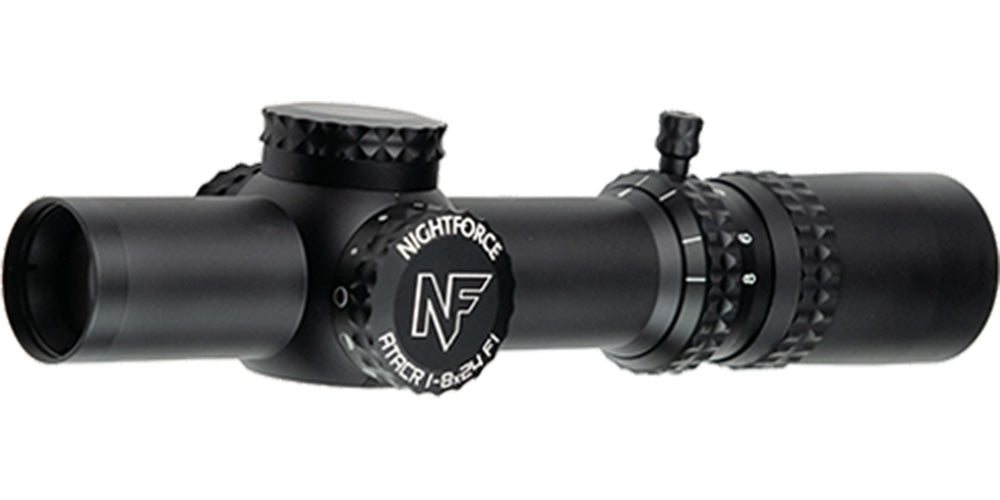 A black Nightforce ATACR 1-8x24 F1 .1 Mil-Radian NVD PTL FC-DMX C653 riflescope by B&B Firearms, featuring a compact, cylindrical design. This low-power variable scope includes an 8x zoom adjustment ring with magnification numbers and a rotatable turret for precise settings. The side prominently displays the "NF" brand logo and model details.