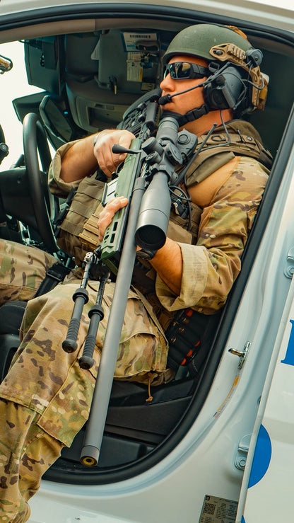 A black, high-precision sniper rifle equipped with a KRG Whiskey 3 Chassis and an adjustable stock. The CheyTac Paladin by B&B Firearms, chambered in .300 Win Mag, features a large telescopic sight on top and a bipod on the front underside of the long and slender barrel. The overall design is sleek and modern.