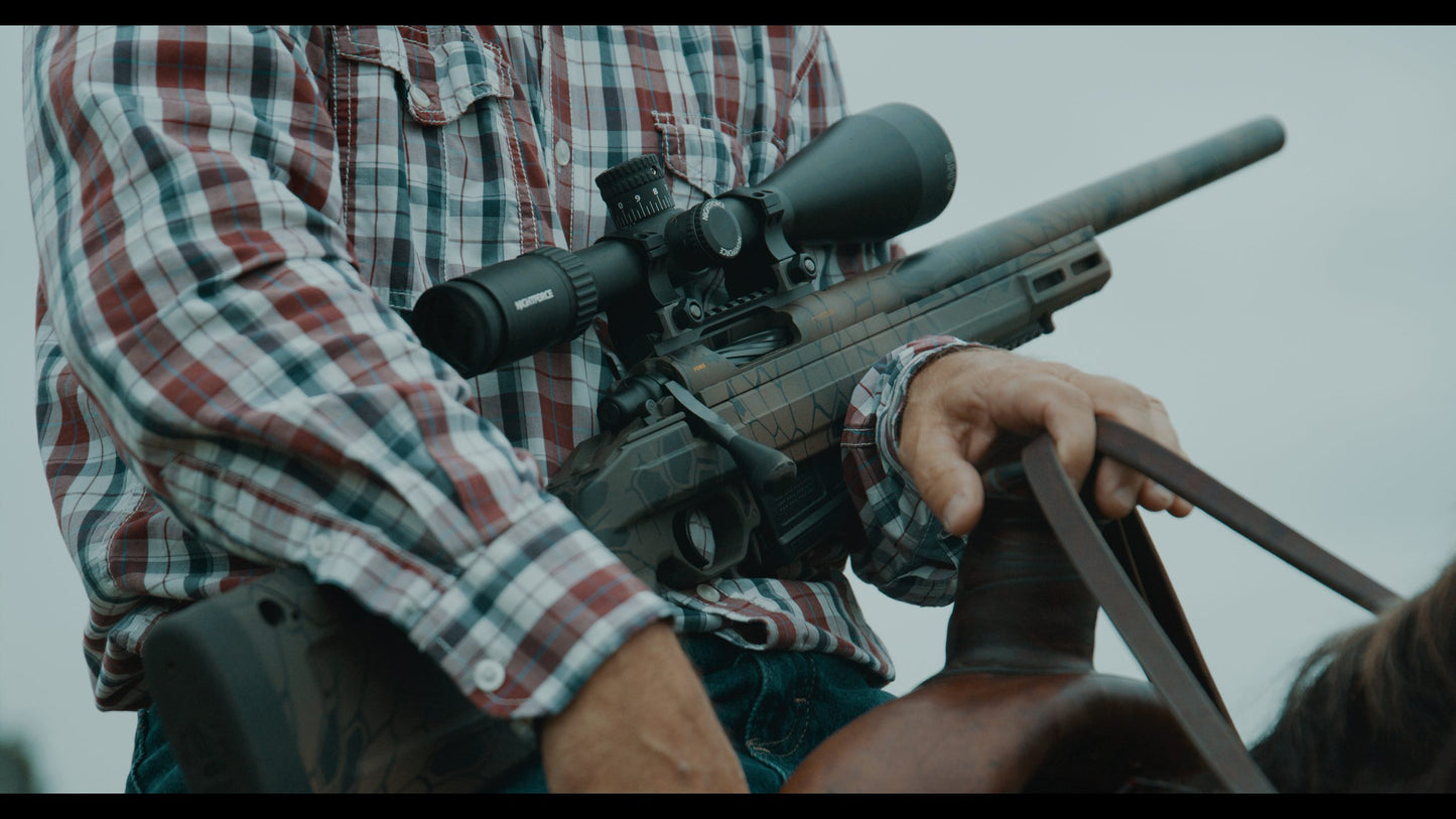 Image of a black precision sniper rifle with a long barrel, an elevated scope, and a bipod attached to the front end. The adjustable stock features a cheek rest, reminiscent of the KRG Whiskey 3. The sleek design indicates it is made for high accuracy shooting. This B&B Firearms CheyTac SAPP rifle is displayed against a plain white background.