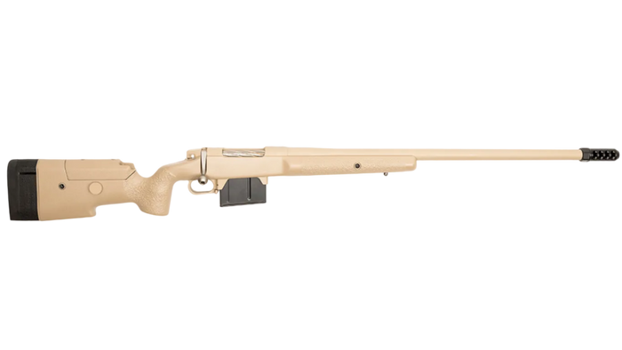 A tan-colored B&B Firearms MCMILLAN TAC-338 sniper rifle is positioned horizontally against a white background. The tactical rifle features a sleek, minimalist design with a textured grip, a matte finish, and a black magazine. The barrel extends straight, ending with a muzzle brake, and the stock is cushioned with black padding.