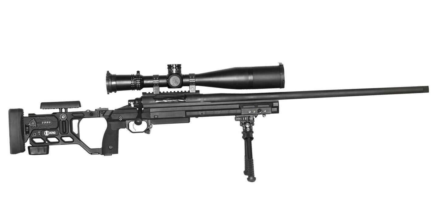 A black, high-precision sniper rifle equipped with a KRG Whiskey 3 Chassis and an adjustable stock. The CheyTac Paladin by B&B Firearms, chambered in .300 Win Mag, features a large telescopic sight on top and a bipod on the front underside of the long and slender barrel. The overall design is sleek and modern.