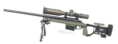 The Cheytac Perses by B&B Firearms is a green and black precision rifle chambered in .338 LM, boasting a long barrel and a large tactical scope mounted on top. Equipped with a bipod, modular stock, ergonomic grip, adjustable cheek rest, and an extended magazine, this firearm is designed for long-range shooting.