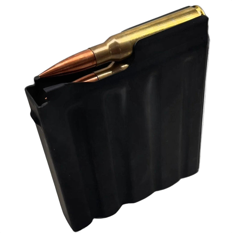 A black rectangular metal object with three vertical indentations resembles a component of the Cheytac M200 .408/.375 Magazine. The right edge features a protruding notch-like structure, and the upper right corner is slightly angled. The matte surface shows signs of mild wear, set against a solid white background. This product is manufactured by B&B Firearms.
