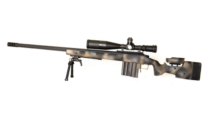 The lightweight **Cheytac M300 Praetorian sniper rifle by B&B Firearms**, favored by competitive shooters, features a long barrel with a bipod near the muzzle, a large scope on top, and a camouflage-patterned stock. Its ergonomic design includes an adjustable cheek rest and a magazine protruding from the bottom. The background is white.